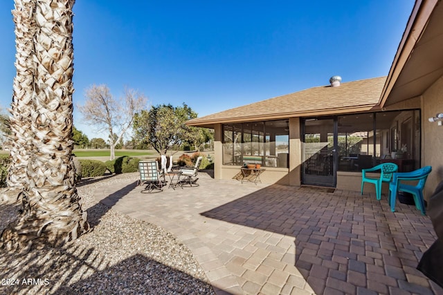 view of patio featuring a sunroom