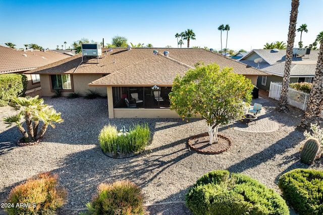 back of property featuring a sunroom and cooling unit