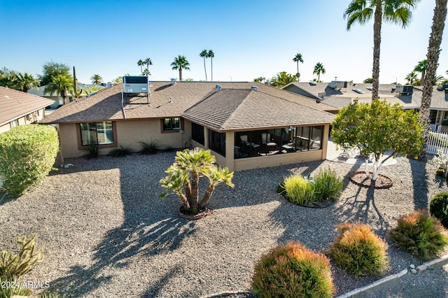 rear view of house featuring a sunroom and cooling unit