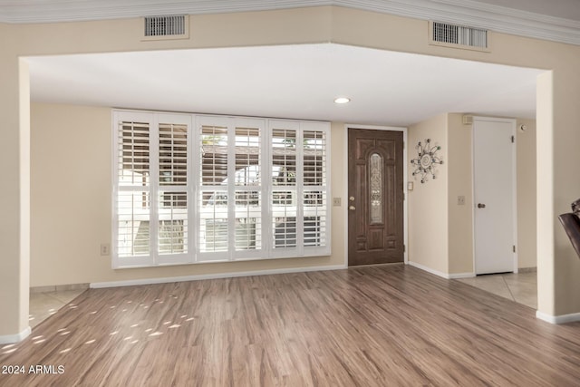 entrance foyer featuring light hardwood / wood-style floors and ornamental molding