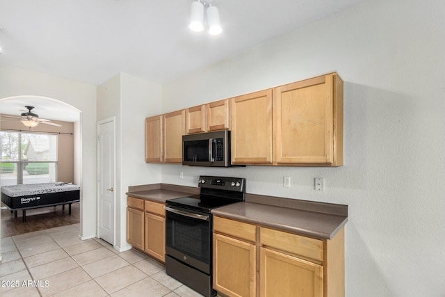 6372 S Callaway Dr, Chandler, AZ 85249 - kitchen featuring arched walkways, range with electric cooktop, dark countertops, stainless steel microwave, and light tile patterned flooring