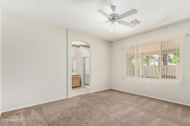 6372 S Callaway Dr, Chandler, AZ 85249 - unfurnished room with visible vents, baseboards, arched walkways, a ceiling fan, and light carpet