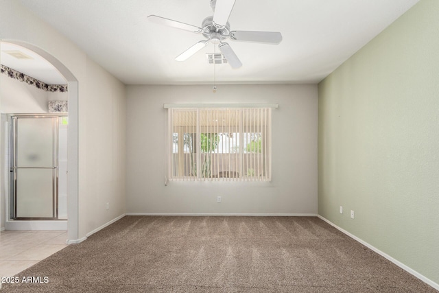 6372 S Callaway Dr, Chandler, AZ 85249 - carpeted spare room featuring arched walkways, visible vents, baseboards, and a ceiling fan
