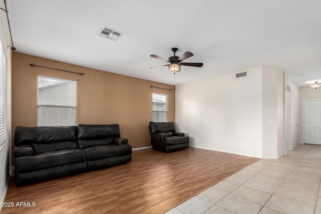6372 S Callaway Dr, Chandler, AZ 85249 - living room with visible vents, ceiling fan, light wood-type flooring, and arched walkways
