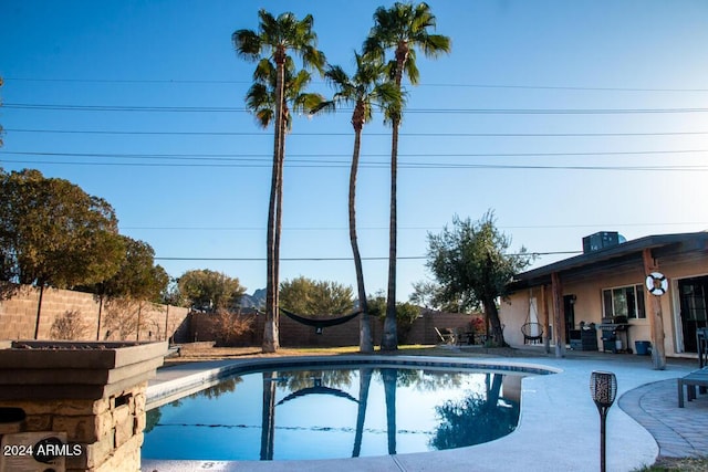 view of swimming pool with a patio