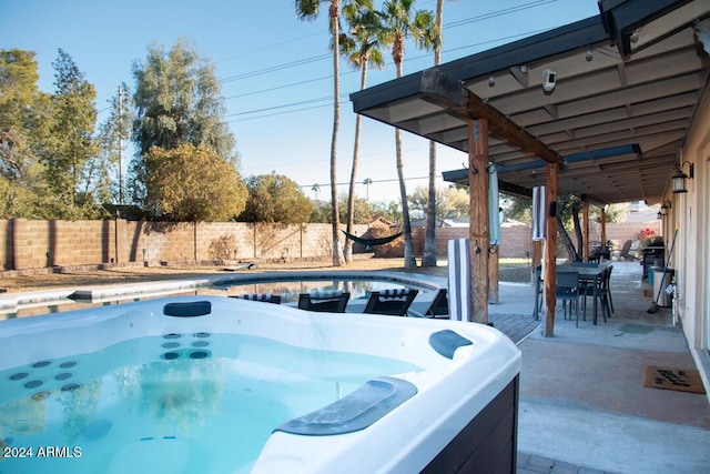 view of swimming pool with a hot tub and a patio area