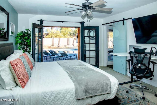 carpeted bedroom with ceiling fan, a barn door, and access to exterior