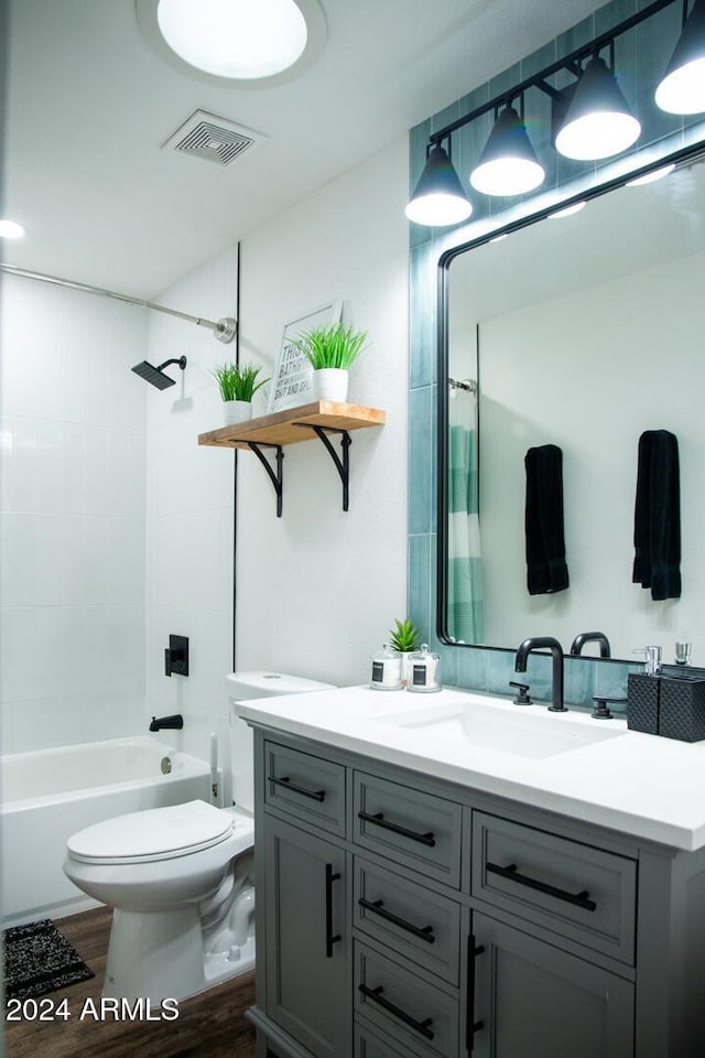 full bathroom with shower / tub combo with curtain, vanity, wood-type flooring, and toilet