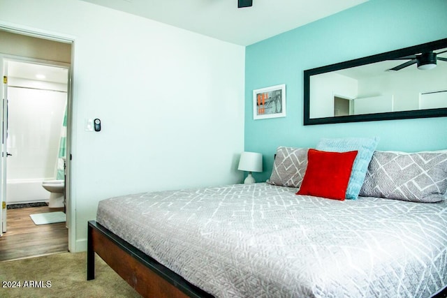 bedroom with carpet floors, ensuite bath, and ceiling fan