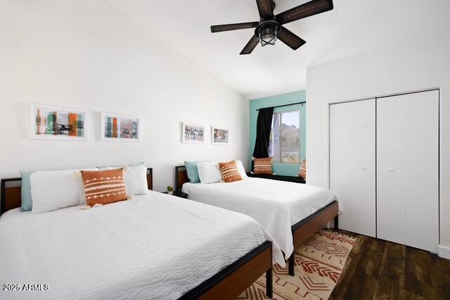 bedroom with hardwood / wood-style floors, ceiling fan, lofted ceiling, and a closet