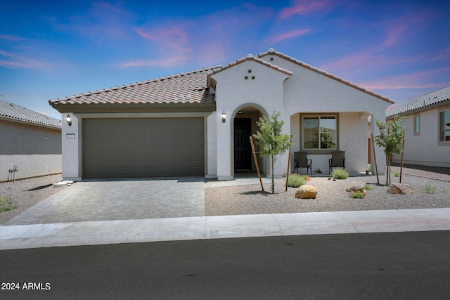 mediterranean / spanish-style house featuring a garage