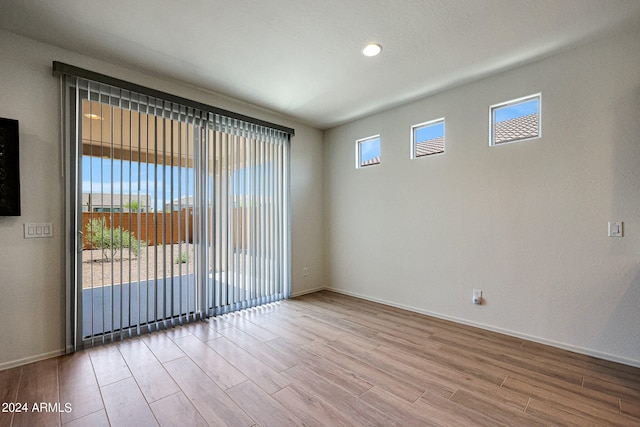 spare room with hardwood / wood-style flooring