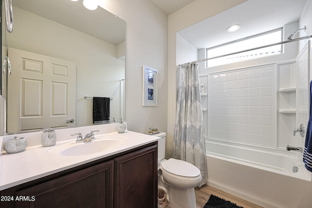 full bathroom featuring large vanity, shower / bath combo with shower curtain, toilet, and wood-type flooring