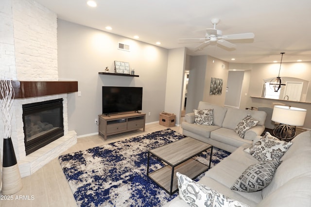7021 E Earll Dr Unit 204, Scottsdale, AZ 85251 - living area with recessed lighting, a stone fireplace, ceiling fan, and baseboards