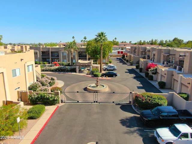 7021 E Earll Dr Unit 204, Scottsdale, AZ 85251 - view of asphalt street featuring a gate, a residential view, curbs, and a gated entry