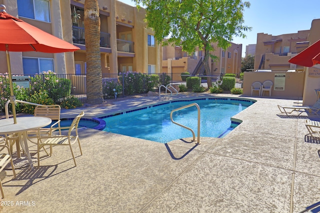 7021 E Earll Dr Unit 204, Scottsdale, AZ 85251 - view of pool with a pool with connected hot tub, a patio area, and a residential view