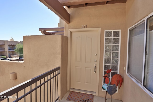 7021 E Earll Dr Unit 204, Scottsdale, AZ 85251 - view of exterior entry with stucco siding and a balcony