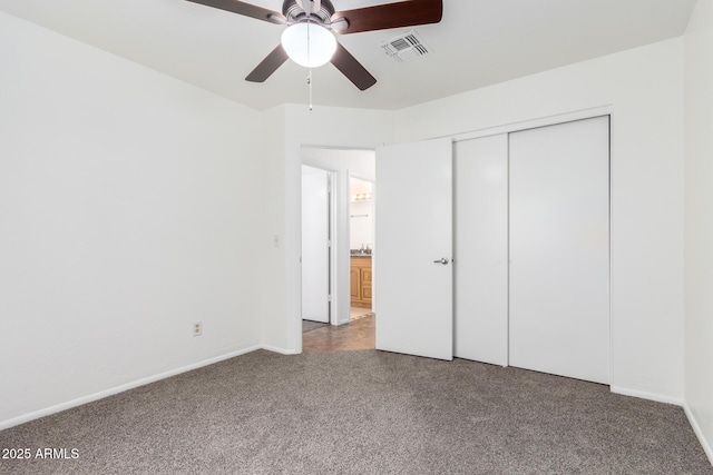 unfurnished bedroom featuring ceiling fan, carpet, and a closet