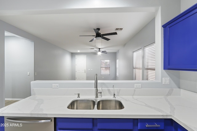 kitchen featuring blue cabinetry, stainless steel dishwasher, a sink, visible vents, and a ceiling fan