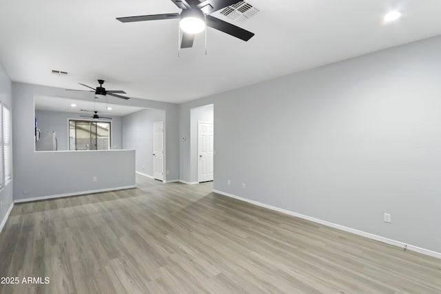 unfurnished room with baseboards, visible vents, light wood-style floors, and a ceiling fan