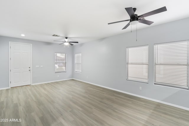 spare room with a ceiling fan, light wood-type flooring, baseboards, visible vents, and recessed lighting