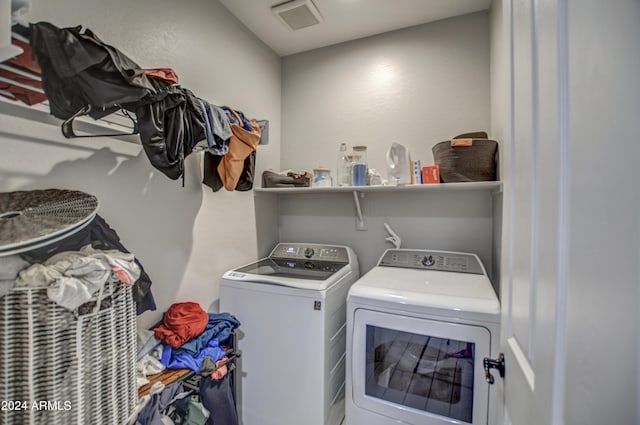 laundry area with washing machine and clothes dryer