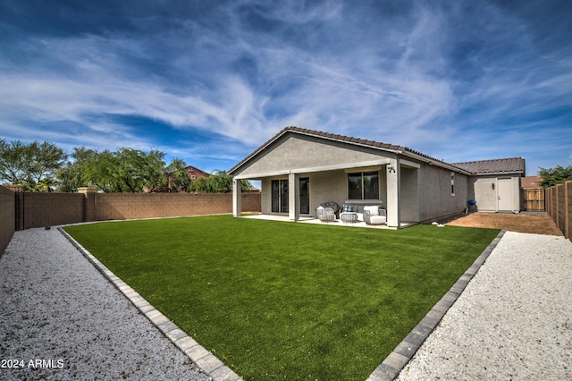 rear view of house featuring a patio area and a yard