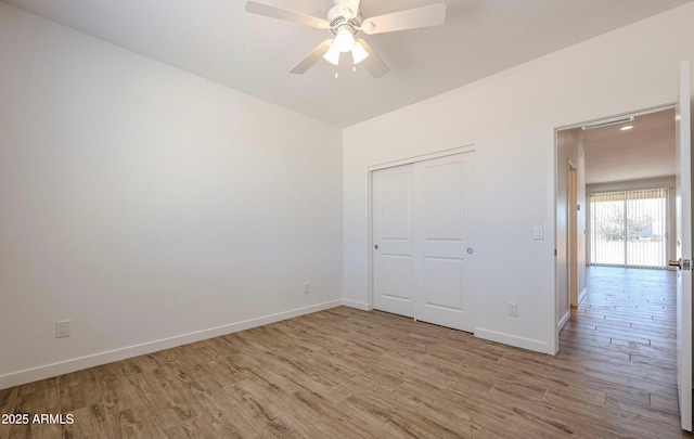 unfurnished bedroom with light wood-type flooring, a closet, and ceiling fan