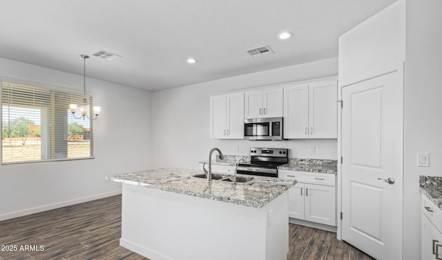 kitchen with white cabinets, an island with sink, appliances with stainless steel finishes, and sink