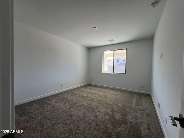 spare room featuring carpet, baseboards, and visible vents