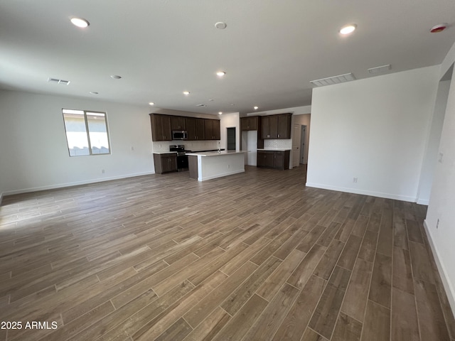 unfurnished living room featuring recessed lighting, visible vents, baseboards, and wood finished floors