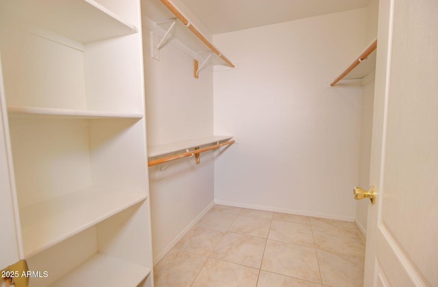 spacious closet with light tile patterned floors