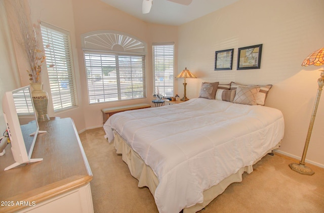 bedroom featuring light carpet and ceiling fan