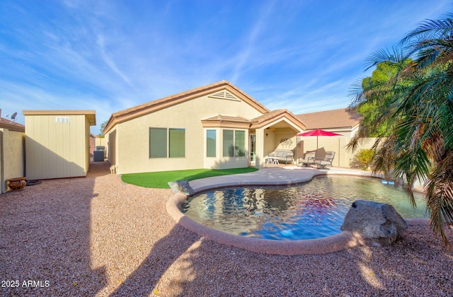 view of swimming pool featuring cooling unit, a patio, and a storage unit