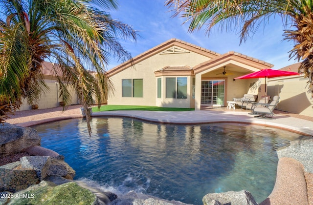 view of pool with ceiling fan and a patio