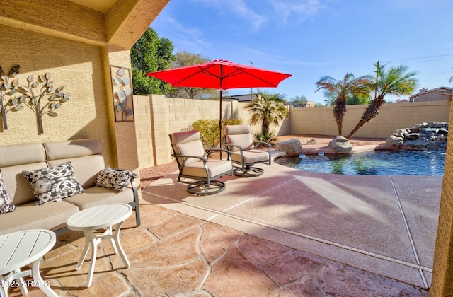 view of patio / terrace featuring a fenced in pool and an outdoor living space