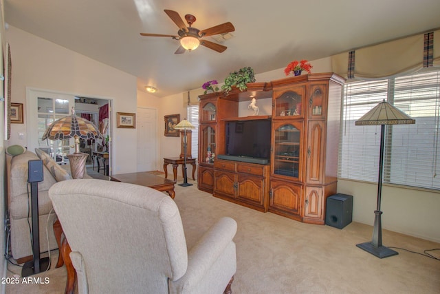 carpeted living room with lofted ceiling and ceiling fan