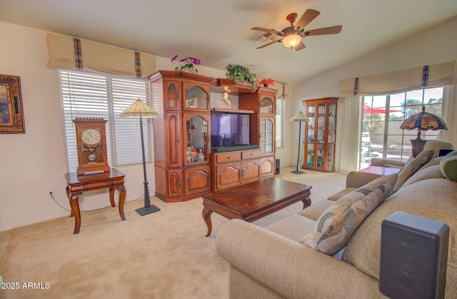 carpeted living room with lofted ceiling and ceiling fan