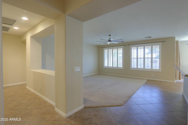 empty room featuring ceiling fan and light tile patterned flooring