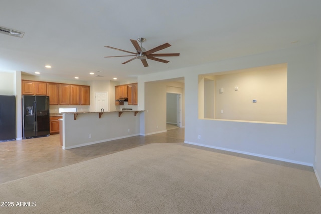 unfurnished living room with ceiling fan