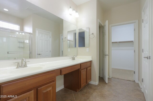 bathroom featuring tile patterned floors, vanity, and an enclosed shower