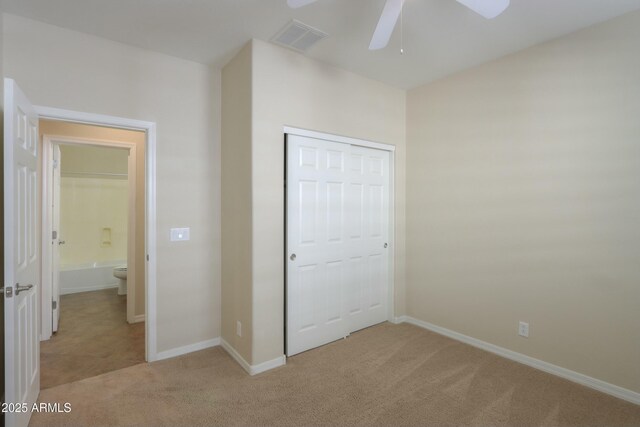 unfurnished bedroom with ceiling fan, a closet, and light colored carpet