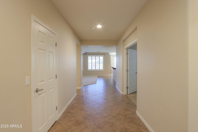 hall featuring light tile patterned floors