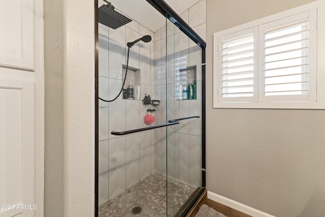 bathroom featuring a stall shower and baseboards