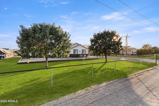 obstructed view of property with fence and a front yard