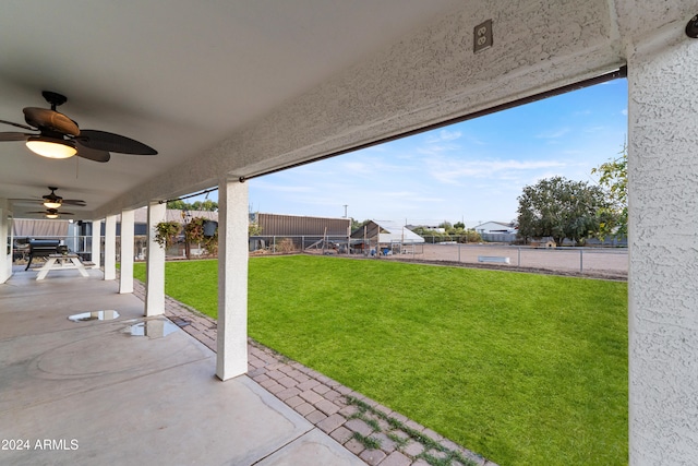 view of yard featuring a ceiling fan, a patio, and fence