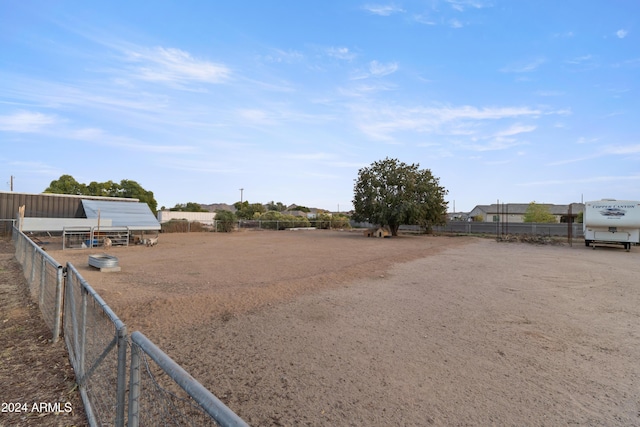 view of yard with fence and an outbuilding