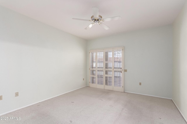 spare room featuring light carpet and ceiling fan