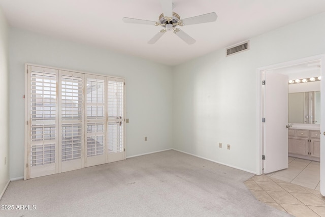 carpeted spare room featuring ceiling fan