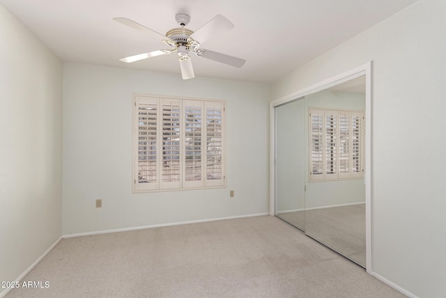 unfurnished bedroom with light carpet, a closet, and ceiling fan